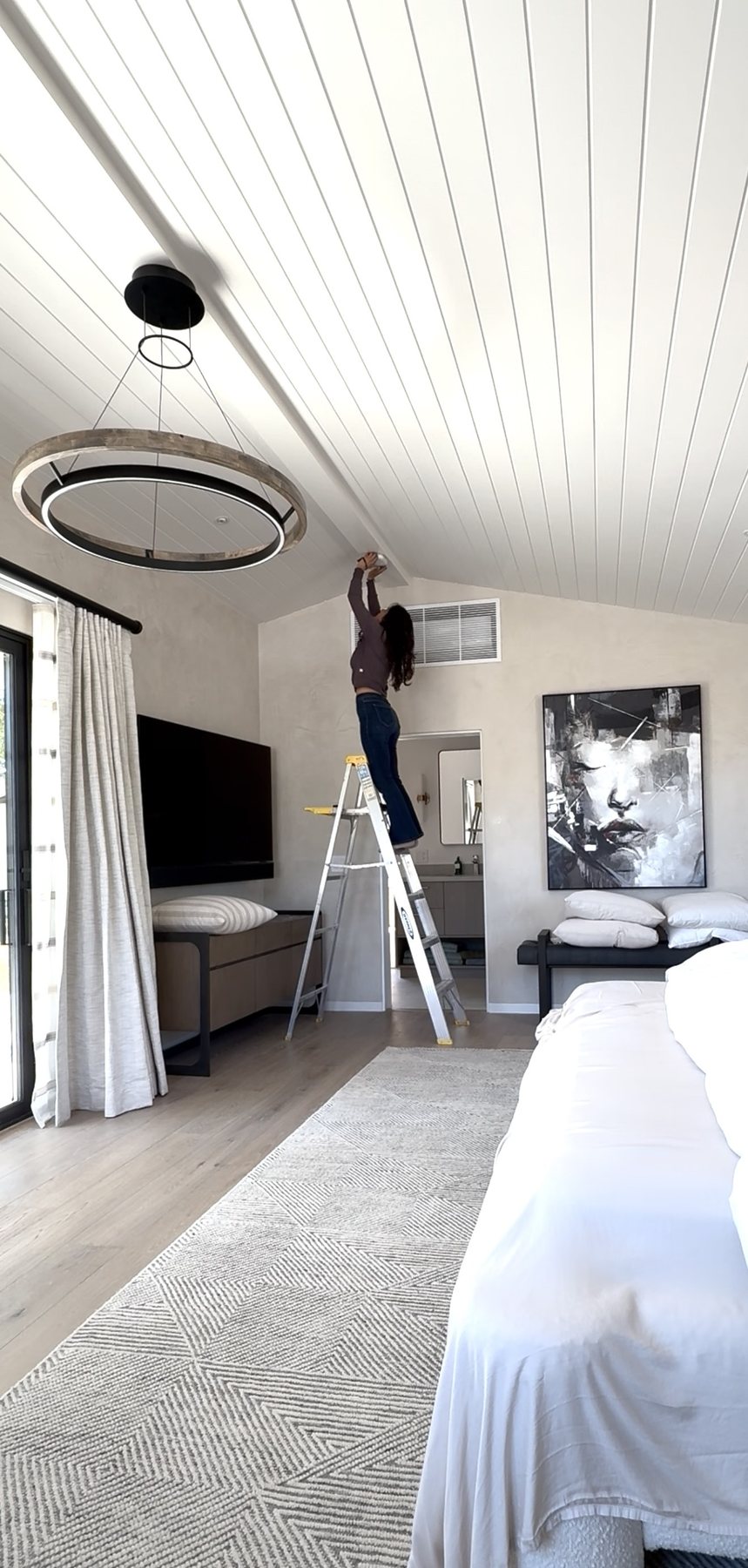 Tiffani Kroop servicing a smoke detector during a home watch visit